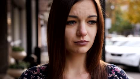 Close-up-portrait-of-an-upset-businesswoman,-girl-distressed-and-crying-on-the-street,-slow-motion