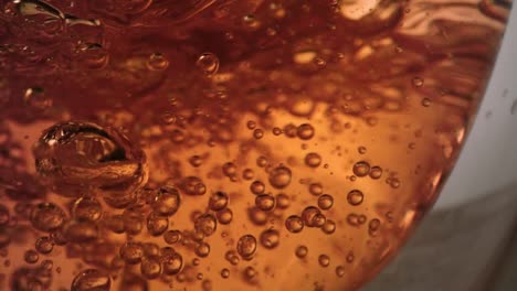 Extreme-close-up-of-air-bubbles-inside-tea-glass