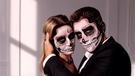 Close-up-view-of-couple-of-painted-halloween-holy-characters-woman-and-man.