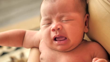 Sweet-crying-newborn-baby-at-mother-on-hands