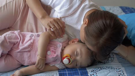 Mother-Kissing-Her-Sleeping-Child