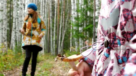 Mom-teaches-her-little-daughter-to-pick-mushrooms.