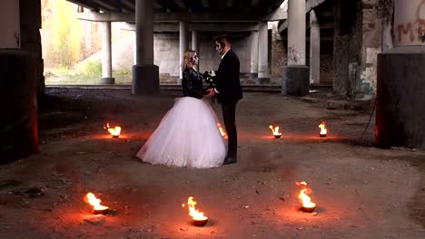 Scary-couple-with-creepy-makeup-on-Halloween-with-fire-and-burning-torches.