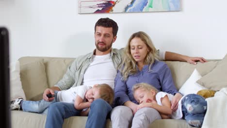 Couple-with-Sleepy-Children-Watching-TV