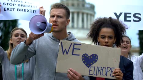 Activists-chanting-in-megaphone,-love-Europe-without-borders,-migration-crisis