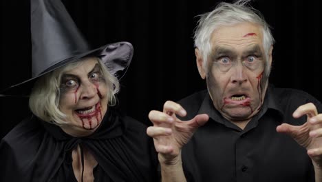 Elderly-man-and-woman-in-Halloween-costumes.-Witch-and-zombie