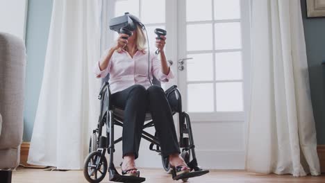 Mature-Disabled-Woman-In-Wheelchair-At-Home-Using-Virtual-Reality-Headset-Gaming-Holding-Controllers