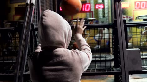 Girl-enjoy-play-basketball-game-and-different-attractions-inside-an-amusement-arcade