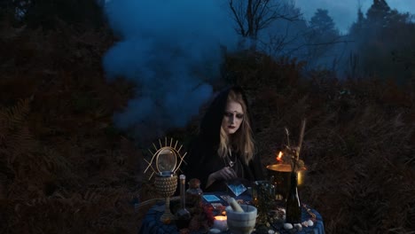 Halloween.-Young-Witch-Spells-At-The-Table.