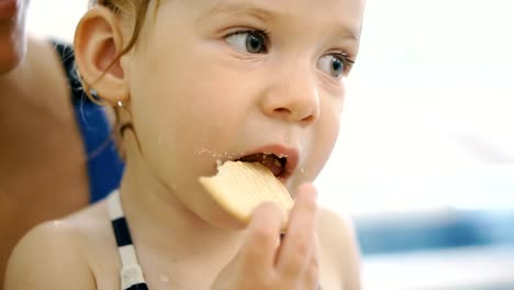 The-child-eats-cookies.-The-child-after-eating-in-the-pool-eats-cookies.