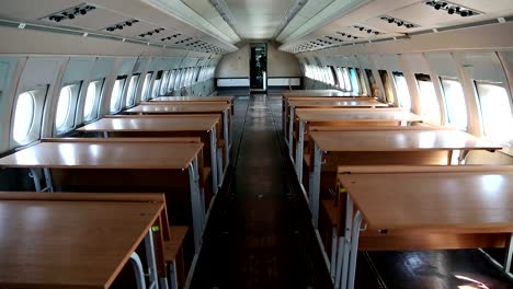 Interior-of-old-airliner-with-desks