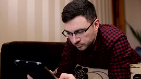 Technology,-vision-and-people-concept---man-with-tablet-pc-tired-from-eyeglasses-at-home