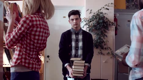 Young-people-gathering-pile-of-books