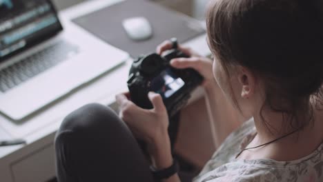 Female-photographer-reviewing-photos-on-her-camera