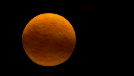 Macro-of-orange-circular-pill-slowly-dissolving-in-water-with-black-abstract-background