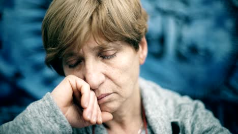 portrait-of-sad,pensive-mature-lady-looking-at-camera