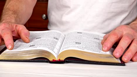 Man-reading-from-the-holy-bible,-close-up