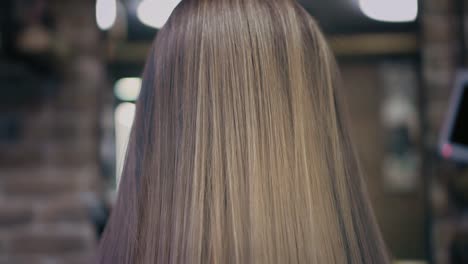 Closeup-down-up-view-on-dyed-pink-and-blonde-woman's-hair-in-hair-salon.-Back-view