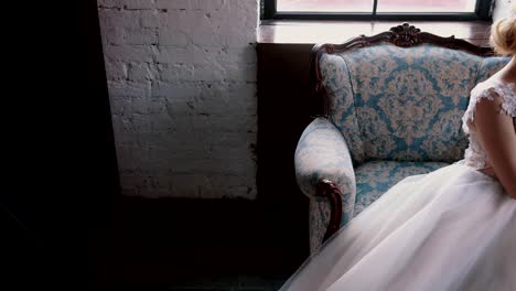 young-bride-holding-a-bouquet-sitting-in-a-chair