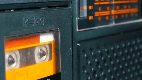 The-Vintage-Yellow-Audio-Cassette-in-the-Tape-Recorder-Rotates