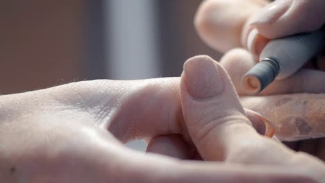 Extreme-Close-up,-Manicure-Master-Cleans-Old-Luck-Nails-on-Woman's-Hand