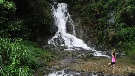 Healthy-lifestyle-woman-practice-yoga-near-waterfall-in-forest