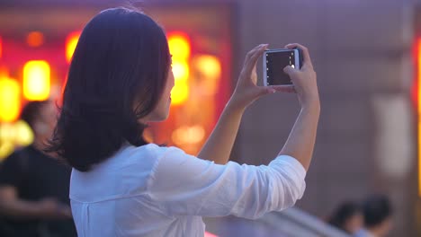 Pretty-young-woman-using-phone-taking-picture