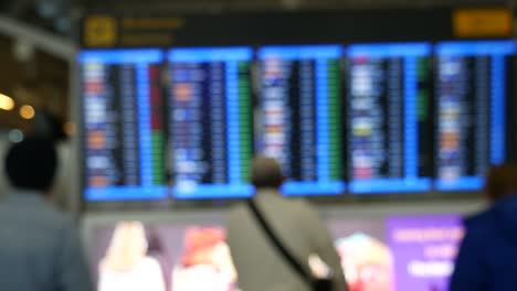 People-at-departure-board-in-airport