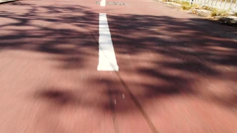 Slow-Motion-Shot:-Close-up-red-road-and-moving-following-the-way