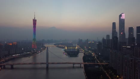 Sonnenuntergang-beleuchtet-Guangzhou-Stadt-Innenstadt-Kanton-Turm-Fluss-Brücke-aerial-Panorama-4k-china