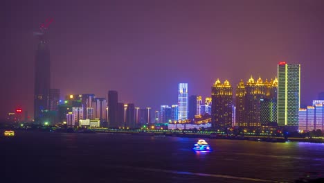 night-illuminated-wuhan-city-riverside-megatall-building-bay-panorama-4k-time-lapse-china