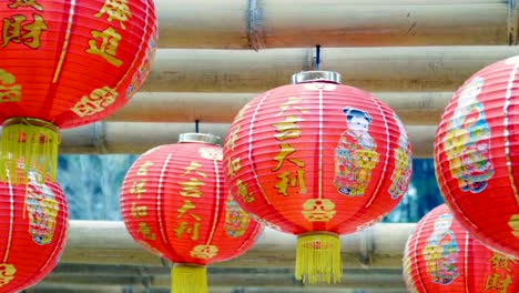 Chinese-new-year-lanterns-hanging-on-bamboo-wood-,blessing-text-mean-have-wealth-and-happy