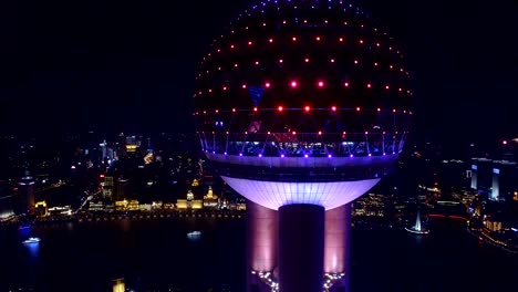 AERIAL-shot-of-Oriental-Pearl-TV-Tower-and-cityscape-at-night,