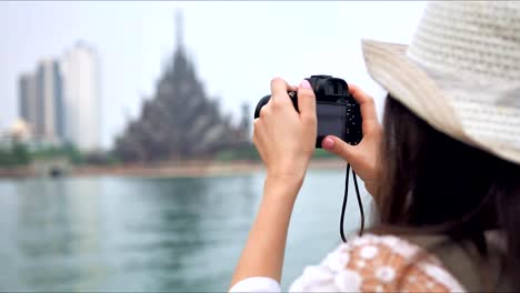 Tourist-woman-taking-photo-picture-of-the-asian-temple