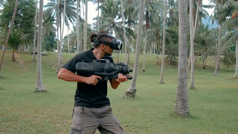 Man-with-weapon-playing-virtual-reality-game-in-the-jungle