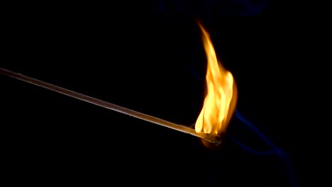 Burning-match-on-a-black-background-in-slow-motion