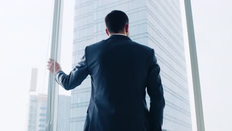 Low-Angle-Following-Shot-of-the-Confident-Businessman-in-a-Suit-Walking-Through-His-Office-and-Looking-out-of-the-Window-Thoughtfully.-Stylish-Modern-Business-Office-with-Big-City-View.