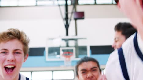 Portrait-Of-Competitive-Male-High-School-Basketball-Team-With-Coach-On-Court