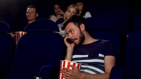 Man-talking-on-his-phone-at-the-movie-theatre