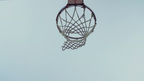 Basketball-going-through-outdoor-basketball-hoop