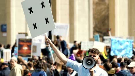 Riot-in-city.-A-boy-with-a-blank-poster-in-your-hands-for-your-title-slow-motion