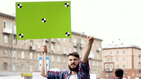 European-people-at-rally.-Caucasian-man-with-a-banner-screaming-into-mouthpiece.