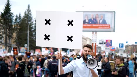 Man-at-political-meeting-with-banner-with-points-for-tracking-to-copy-space-text