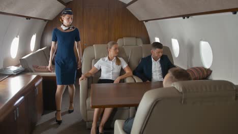 Pretty-stewardess-offers-help-and-service-for-luxury-private-jet-owners