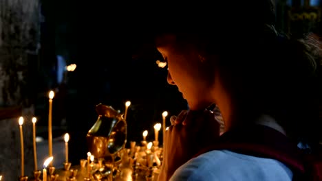 Woman-tourist-recites-a-prayer-in-an-Orthodox-Catholic-ancient-church