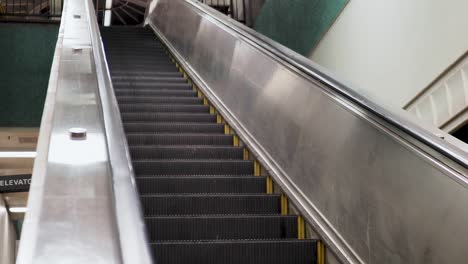 Angled-shot-of-escalator-going-down-in-underground-subway-station