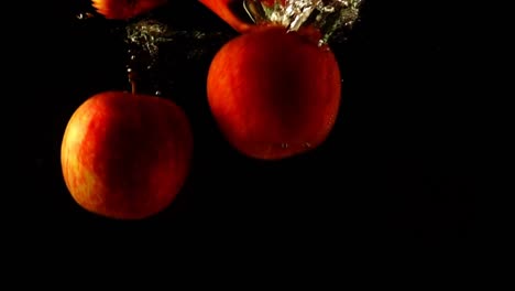 Falling-of-apples-in-water.-Slow-motion.