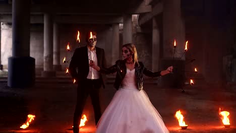 Scary-couple-with-creepy-makeup-on-Halloween-with-fire-and-burning-torches.