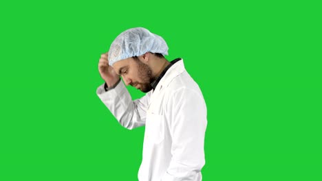 Doctor-man-walking-stressed-with-hand-on-head,-shocked-with-shame-and-surprise-face,-angry-and-frustrated-Fear-and-upset-for-mistake-on-a-Green-Screen,-Chroma-Key