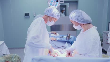 Medical-Team-Performing-Surgical-Operation-in-Bright-Modern-Operating-Room.